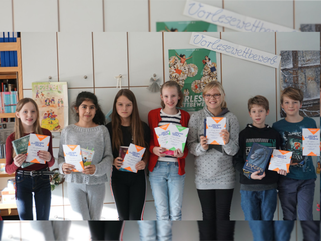 Die Schülerinnen und Schüler präsentieren stolz ihre Urkunden vom Vorlesewettbewerb