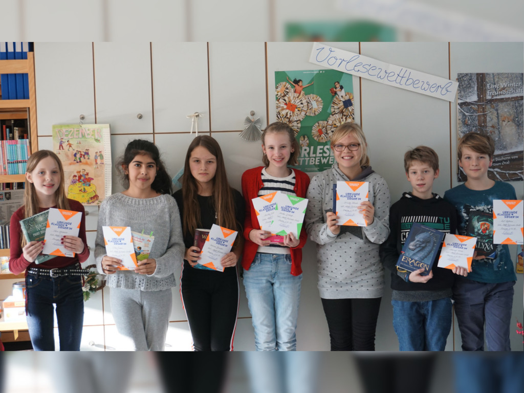 Schüler und Schülerinnen halten eine Urkunde in der Hand